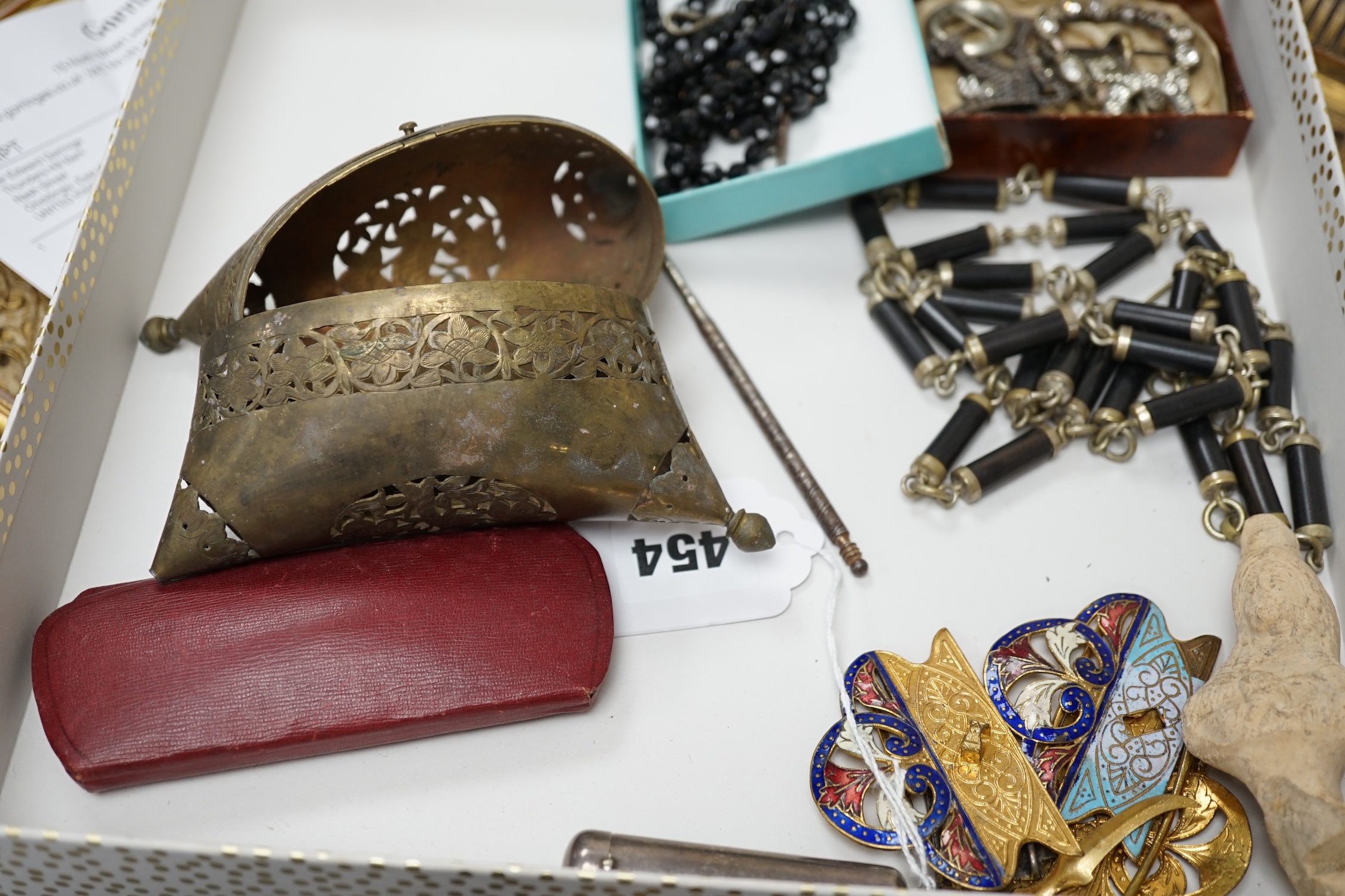 Mixed collectibles to include enamel belt buckles, a silver cased amber and gold mounted cigarette holder, Japanese lacquered case, fans etc